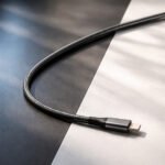 Premium USB-C cable connecting two distinct surface tones representing USB-IF and MFi certification choices